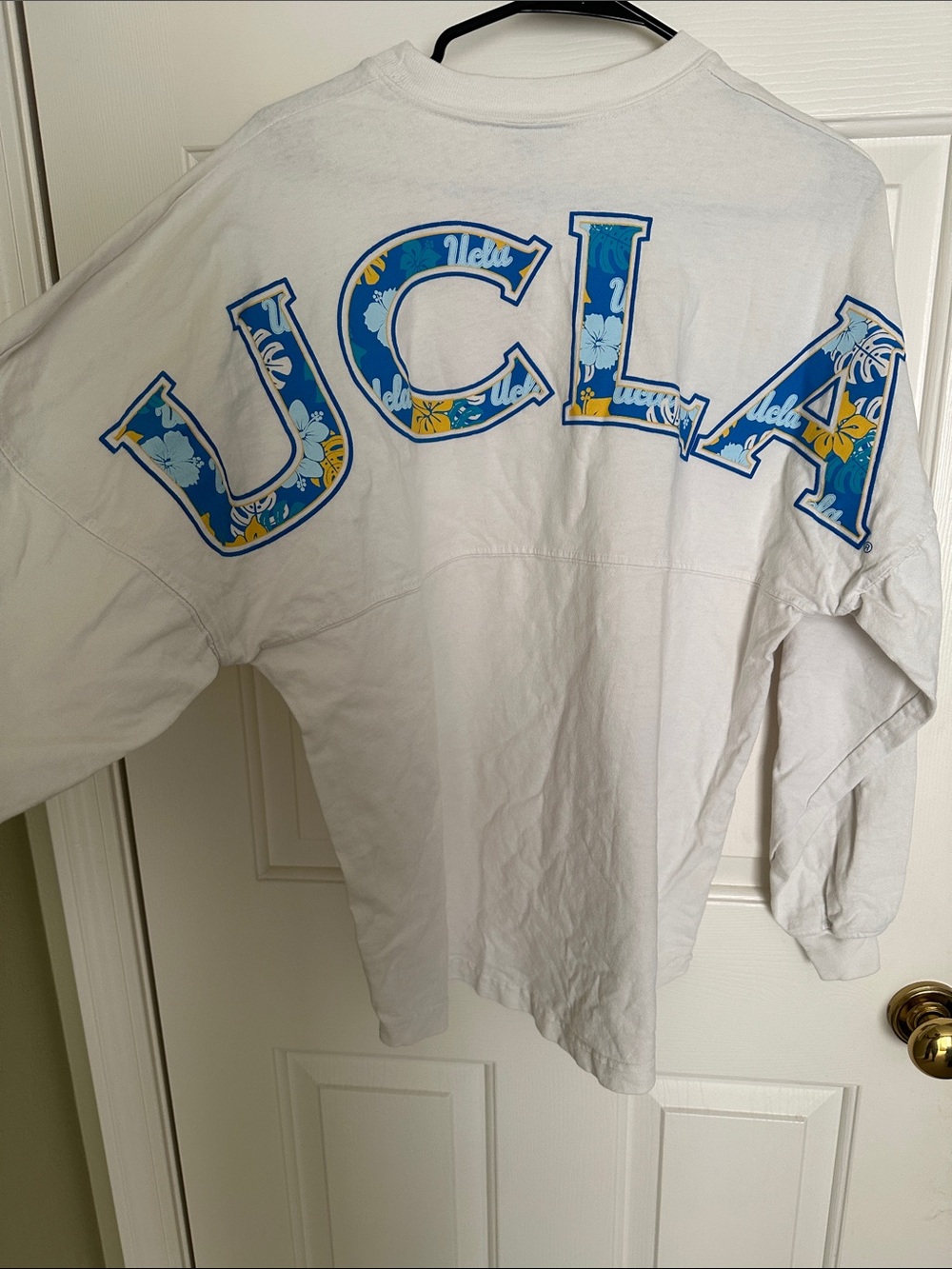 UCLA White Graphic Long Sleeve Top with Blue Floral Logo